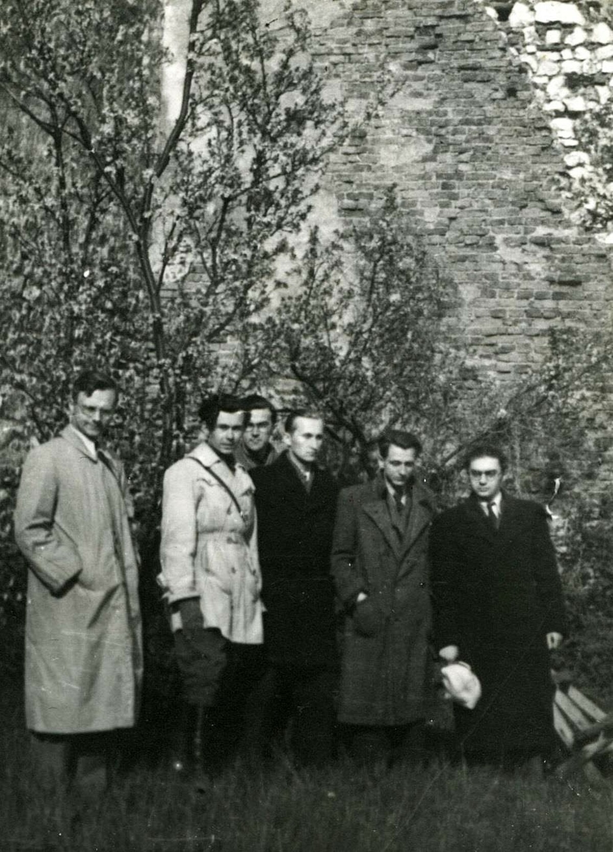 Wycieczka Koła Historyków UMK w Toruniu, Tyniec, 4 maja 1947 r. Od lewej stoją: Andrzej Tomczak, Jerzy Serczyk, Tadeusz Grudziński, Marian Biskup, Janusz Bieniak. Źródło: <a href='https://www.historia.umk.pl/panel/wp-content/uploads/90_lat_prof_bieniak.pdf'>WNH UMK w Toruniu</a>.